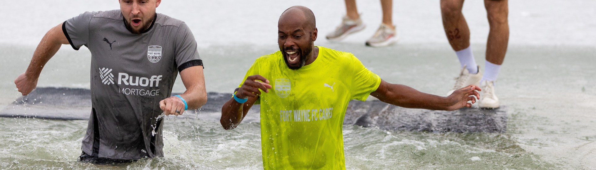 Fort Wayne FC's Director of Football Operations DaMarcus Beasley, right, and Assistant Coach Keelan Barker plunge into the Metea County Park waters to support Special Olympics Indiana